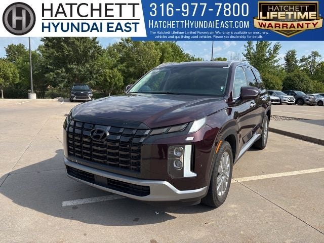 2024 Hyundai Palisade SEL 7 Passenger in Sierra Burgundy — front three-quarter view